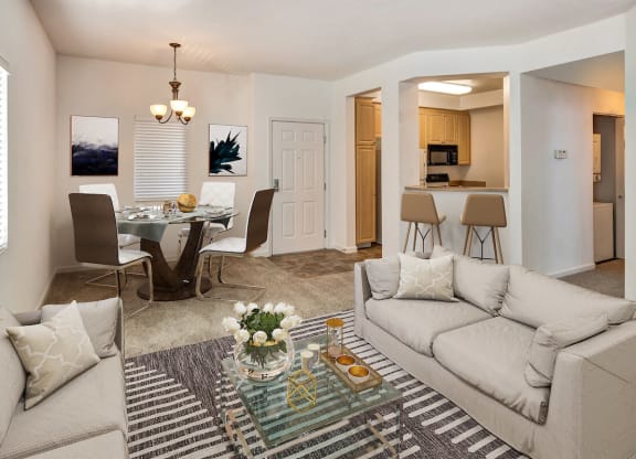 a living room with a couch and a table with chairs  at Falcon Bridge at Gale Ranch, California, 94582