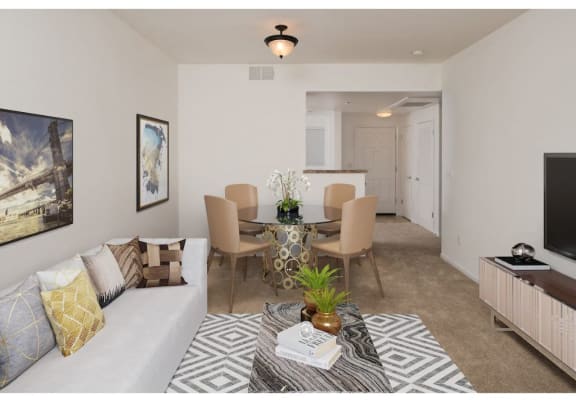 a living room with a couch and a table with a plant on top of it  at Seville at Gale Ranch, San Ramon, CA