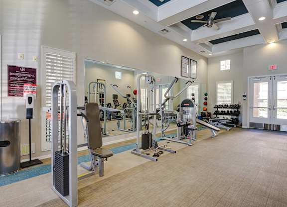 A gym with a variety of equipment including a treadmill, weights, and a bench at Sonoma at Porter Ranch, CA, 91326