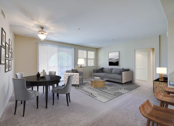 a living room with a table and chairs and a couch  at Sonoma at Porter Ranch, Porter Ranch, CA, 91326