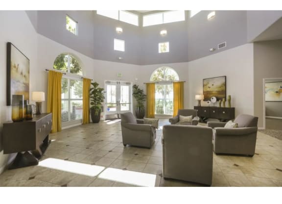 a large living room with couches and chairs  at Tesoro Senior Apartments, Porter Ranch, CA, 91326