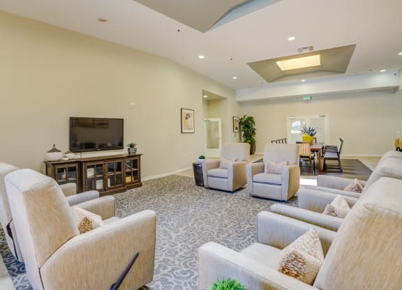 a living room filled with furniture and a flat screen tv  at Tesoro Senior Apartments, California