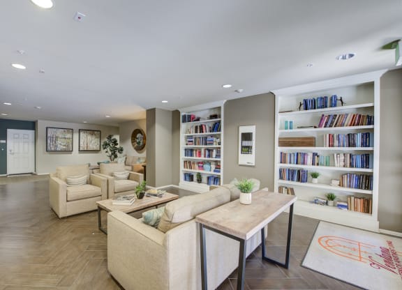 a living room filled with furniture and a large bookshelf  at Ventana Senior Apartments, Northridge, CA, 91326