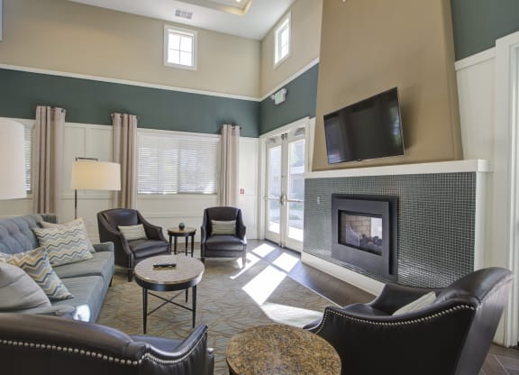 a living room with a fireplace and a tv  at Ventana Senior Apartments, Northridge, 91326