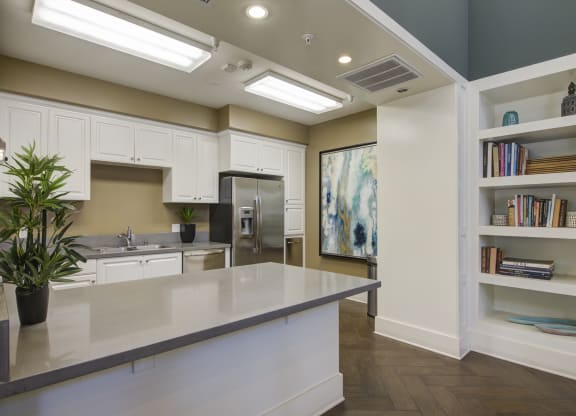 a kitchen with white cabinets and a large island  at Ventana Senior Apartments, Northridge