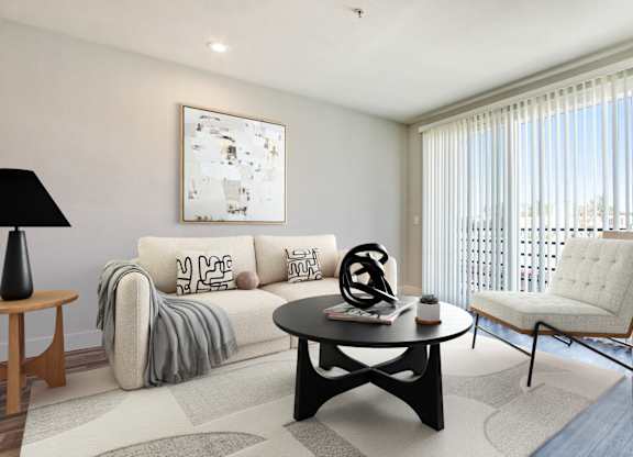 A living room with a white couch and a black coffee table.