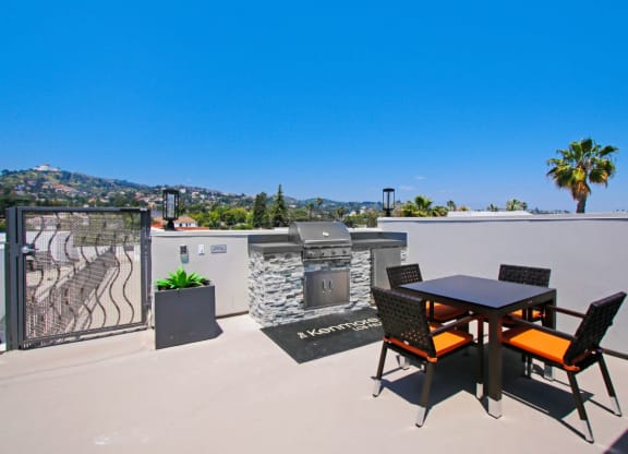 a rooftop patio with a barbecue and a table and chairs at The Kenmore Los Feliz, Los Angeles, CA, 90027-4063