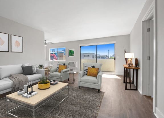 a living room with two couches and a coffee table at Palm Capri Apartments, Burbank