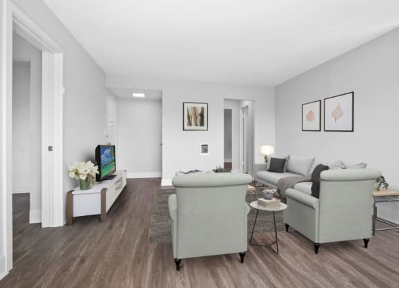 a living room with two couches a coffee table and a tv at Palm Capri Apartments, Burbank, CA