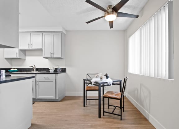 an open kitchen and dining area with a ceiling fan at Clair Del and Clair Del Gardens, Long Beach, 90807