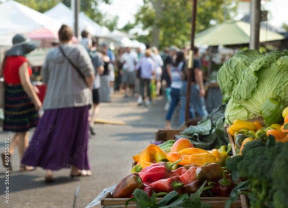 people shopping at a farmers market with vegetables at Darlington Apartments, Los Angeles, CA