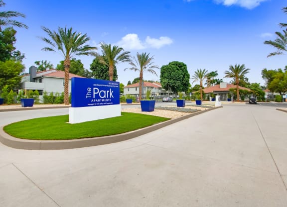 a blue and white sign at the entrance of a parking lot at The Park Apartments, Rancho Cucamonga, CA