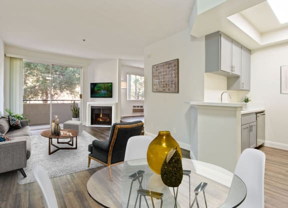 a living room with a glass table and chairs at Palm Royale Apartments, California, 90034
