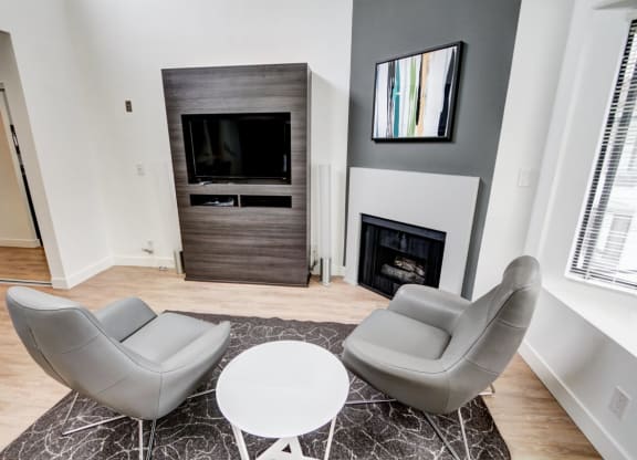 a living room with a fireplace and two couches  at El Greco Lofts, Los Angeles, California