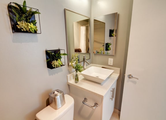 a bathroom with a sink and a mirror  at El Greco Lofts, Los Angeles