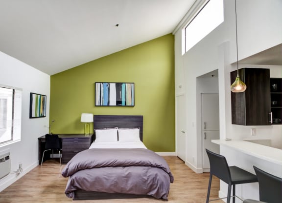 a bedroom with a bed and a desk in a room  at El Greco Lofts, California