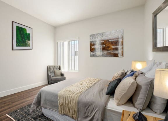 a bedroom with a bed and a chair and a window at Atrium, Los Angeles, California