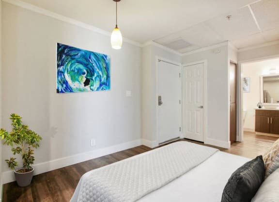 a bedroom with a bed and a painting on the wall at Atrium, Los Angeles, 90024