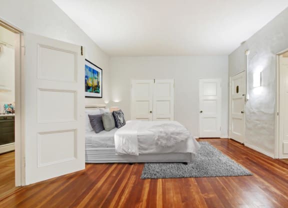 a bedroom with a bed and a door that leads to a bathroom  at 1022 Tiverton, Los Angeles, CA