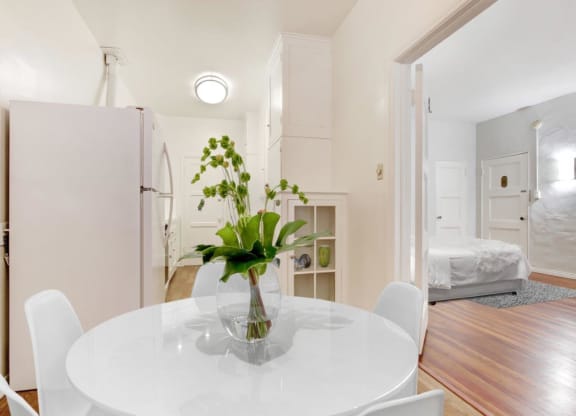 a white table with a vase of flowers on top of it at 1022 Tiverton, Los Angeles, CA