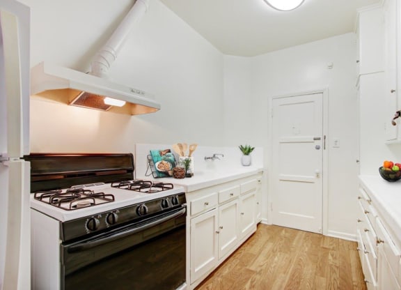 a kitchen with a stove top oven next to a doorway at 1022 Tiverton, Los Angeles, California