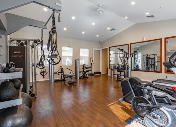 a home gym with exercise equipment and mirrors at Canyon Crest, Riverside, CA