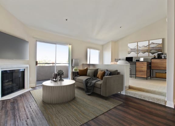 a living room with a couch and a fireplace at Palm Royale Apartments, Los Angeles, CA