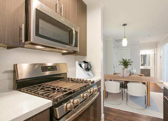 A modern kitchen with a stainless steel oven and microwave.