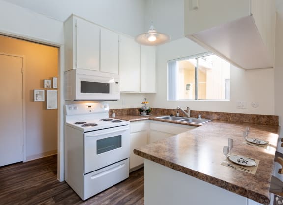 a kitchen with white appliances and a counter top at The Villas at Monarch Beach, Dana Point, 92629