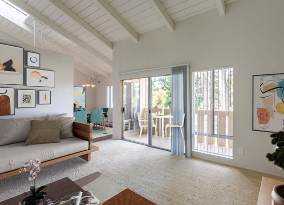 a living room with a couch and a sliding glass door to a patio at The Villas at Monarch Beach, Dana Point, California