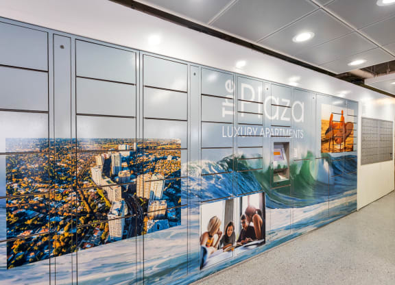 a wall with a large mural of a city on it  at The Plaza Apartments, Los Angeles, CA