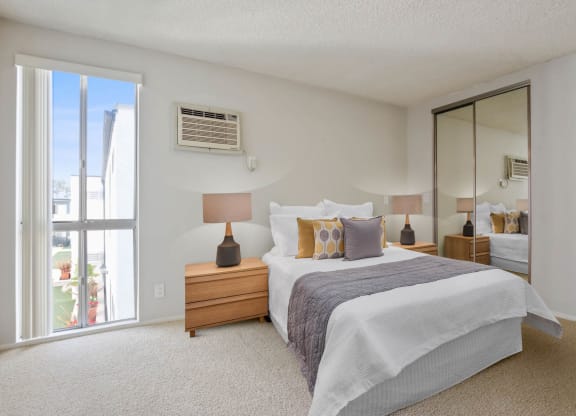 Bedroom white interior with bed at Rose Apartments, Los Angeles, CA, 90034