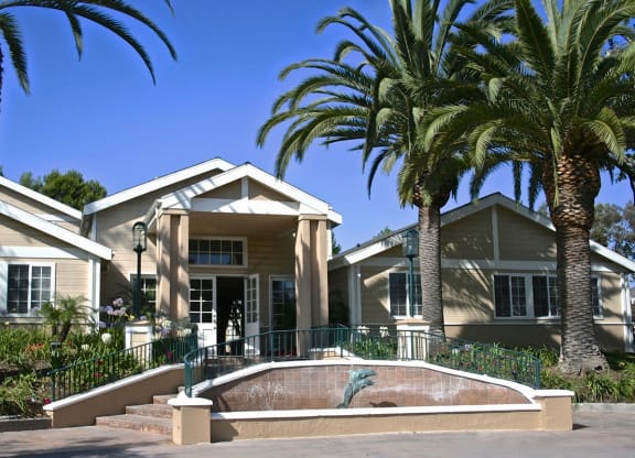 a house with palm trees in front of it at The Villas at Monarch Beach, Dana Point