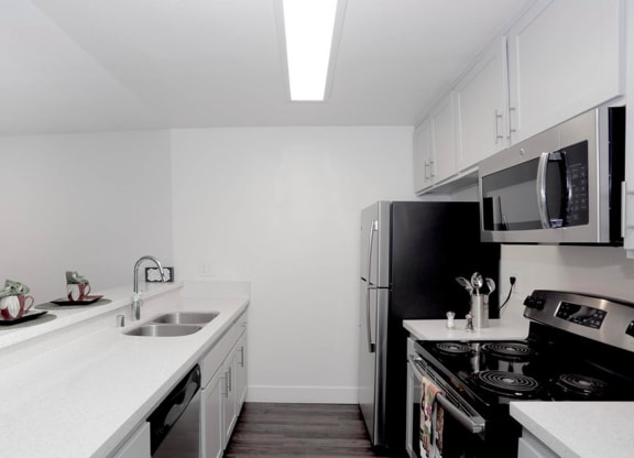 Kitchen area with appliances and cabinetsat Waverly, California