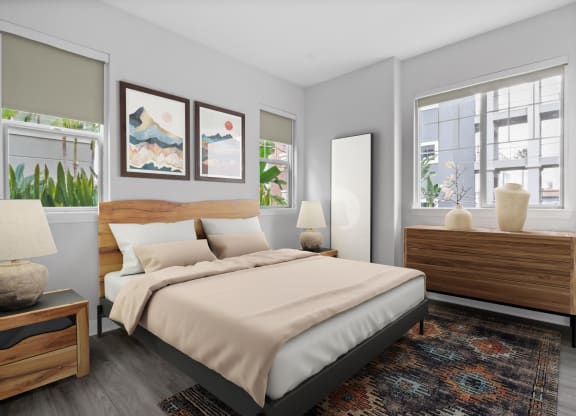 a bedroom with a bed and two windows at The Adler Apartments, Los Angeles, CA