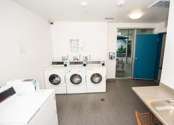 A laundry room with a washer and dryer stacked on top of each other.