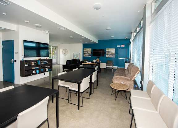 A room with a long table and chairs.