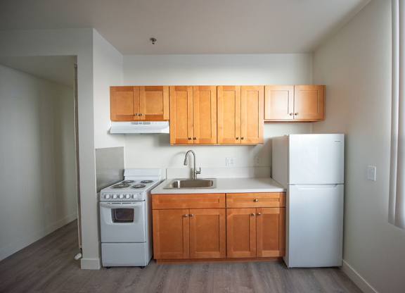 A kitchen with wooden cabinets and white appliances.