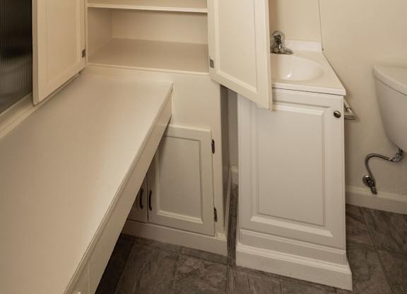 A white bathroom with a toilet and sink.