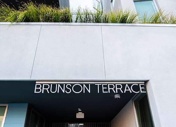 The entrance to a building with the name Brunson Terrace on it.