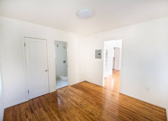 A room with wooden floors and white walls.