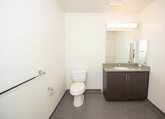 Sample Unit: Bathroom with toilet, sink, and mirror
