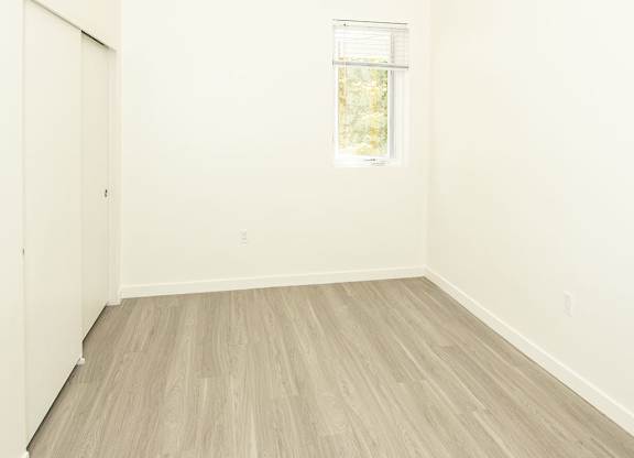 A room with a window and a door.
