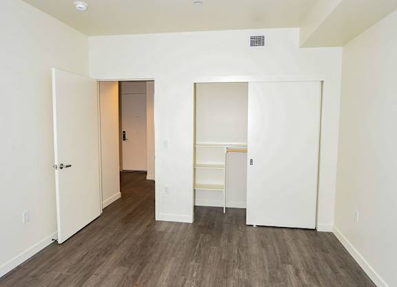 A room with a wooden floor and white walls.