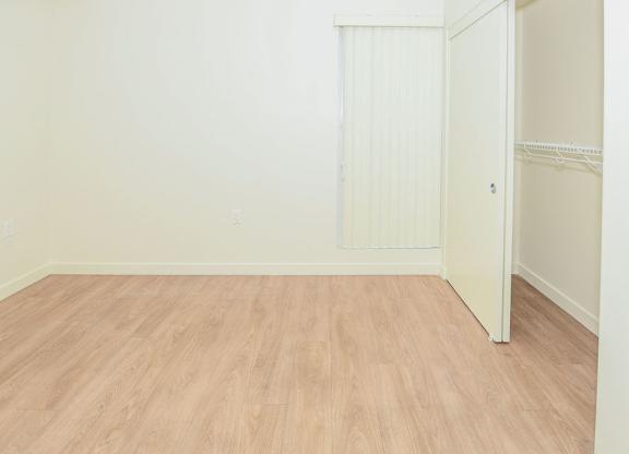 Sample 2 Bed Unit: A bedroom room with a white door and a vinyl floor.