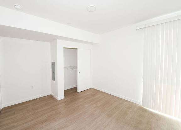 Sample 2 Bed Unit: A room with a white door and a window with blinds.