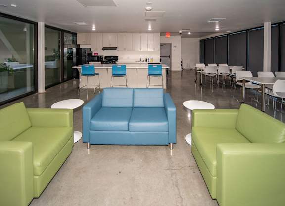 A brightly colored couch and chair set in a modern room.