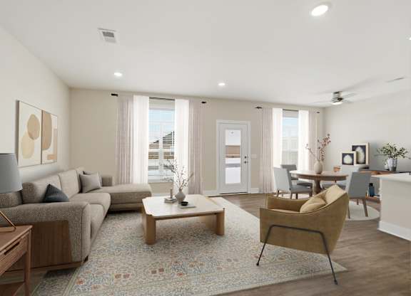 A well-lit living room with a grey sofa, a wooden coffee table, and a yellow armchair.