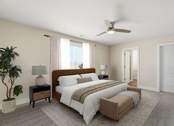 A bedroom with a large bed and a ceiling fan.