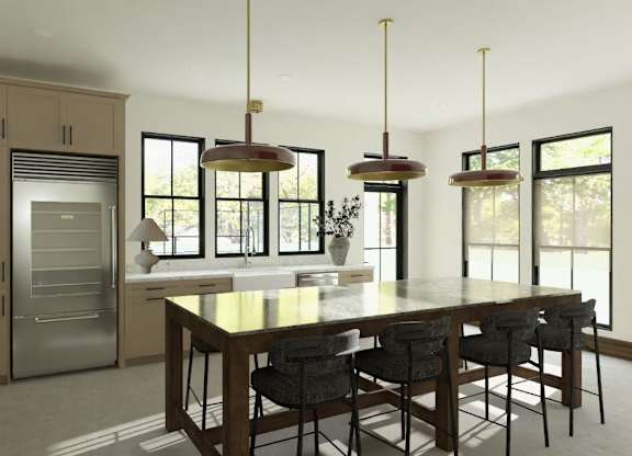 A modern kitchen with a large island and stainless steel appliances.